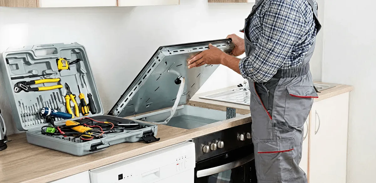Handyman repairing a cooktop and checking wiring connections in Naperville, IL