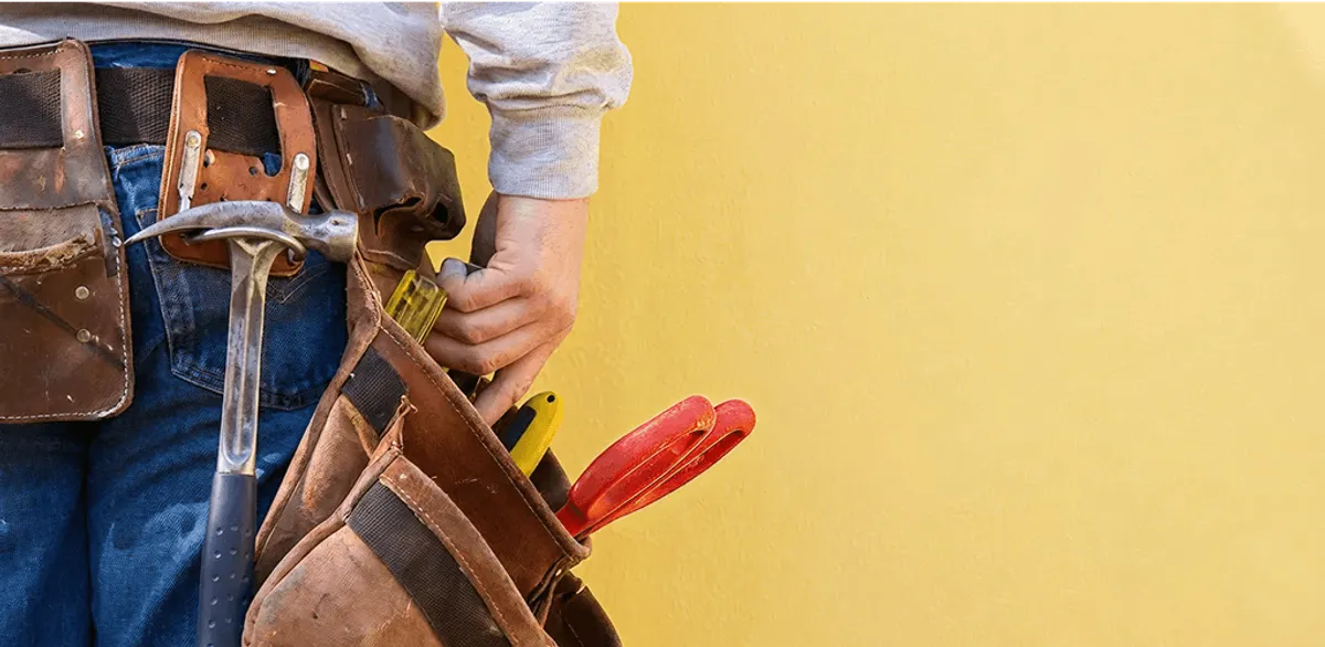 Handyman with tool belt ready for home repairs and maintenance in Naperville, IL