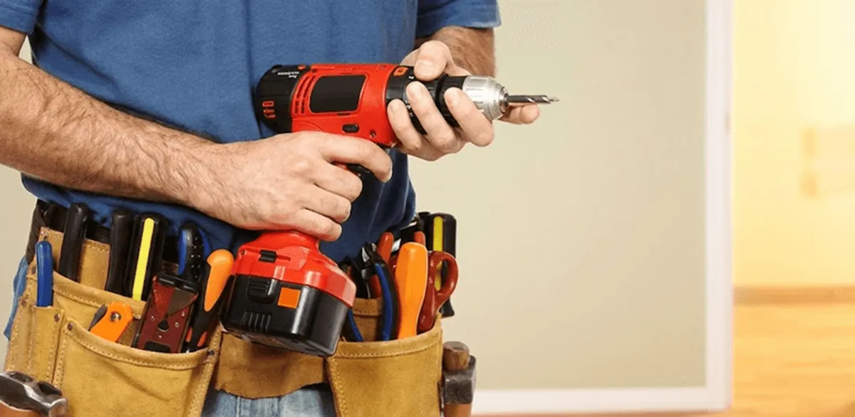 Handyman holding a power drill for home repairs and installations in Naperville, IL